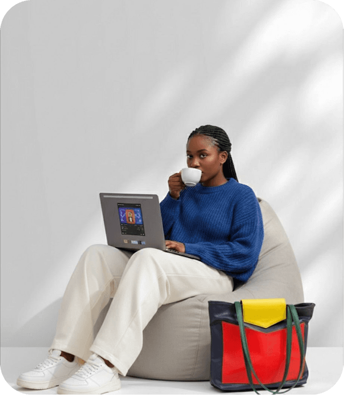 Woman working on a laptop while enjoying a coffee